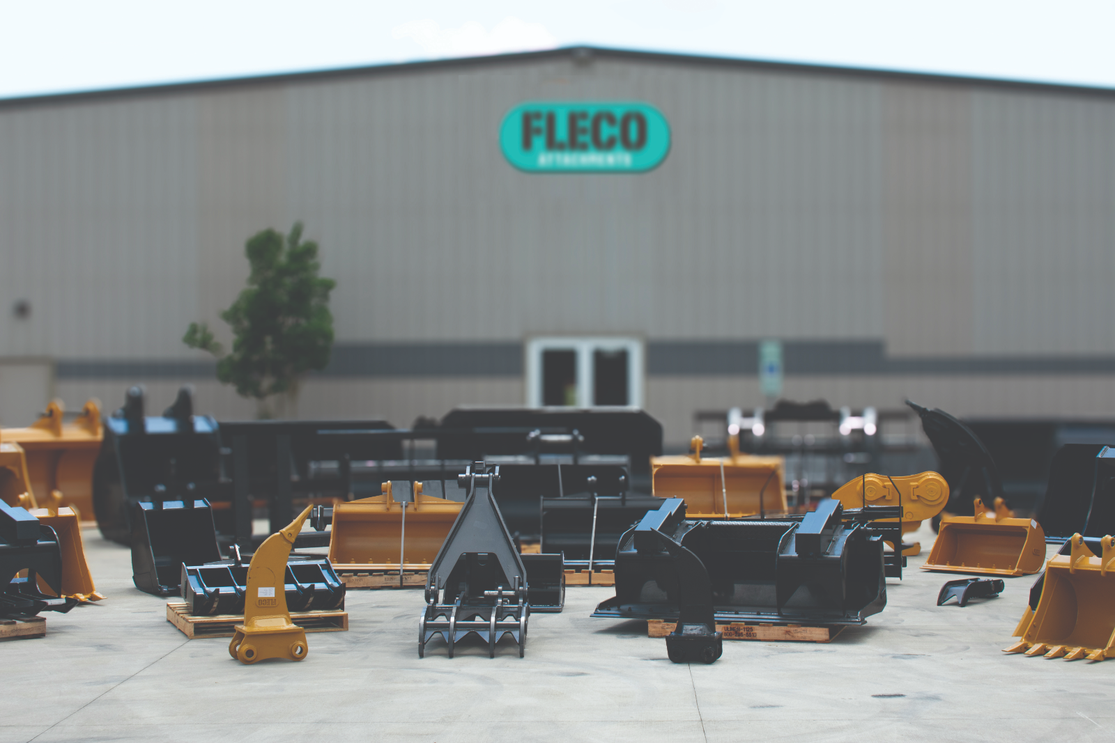 FLECO attachments staged in the yard outside the warehouse